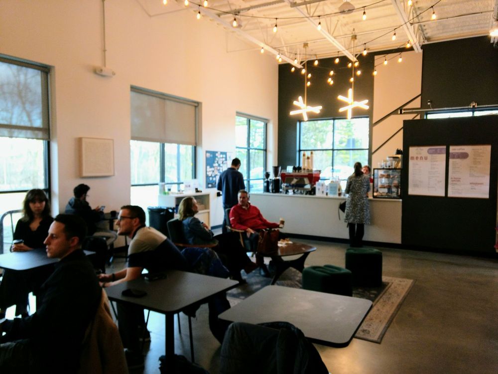 Inside Niyyah Coffee at Hub & Spoke — seating, menu, and specialty bar