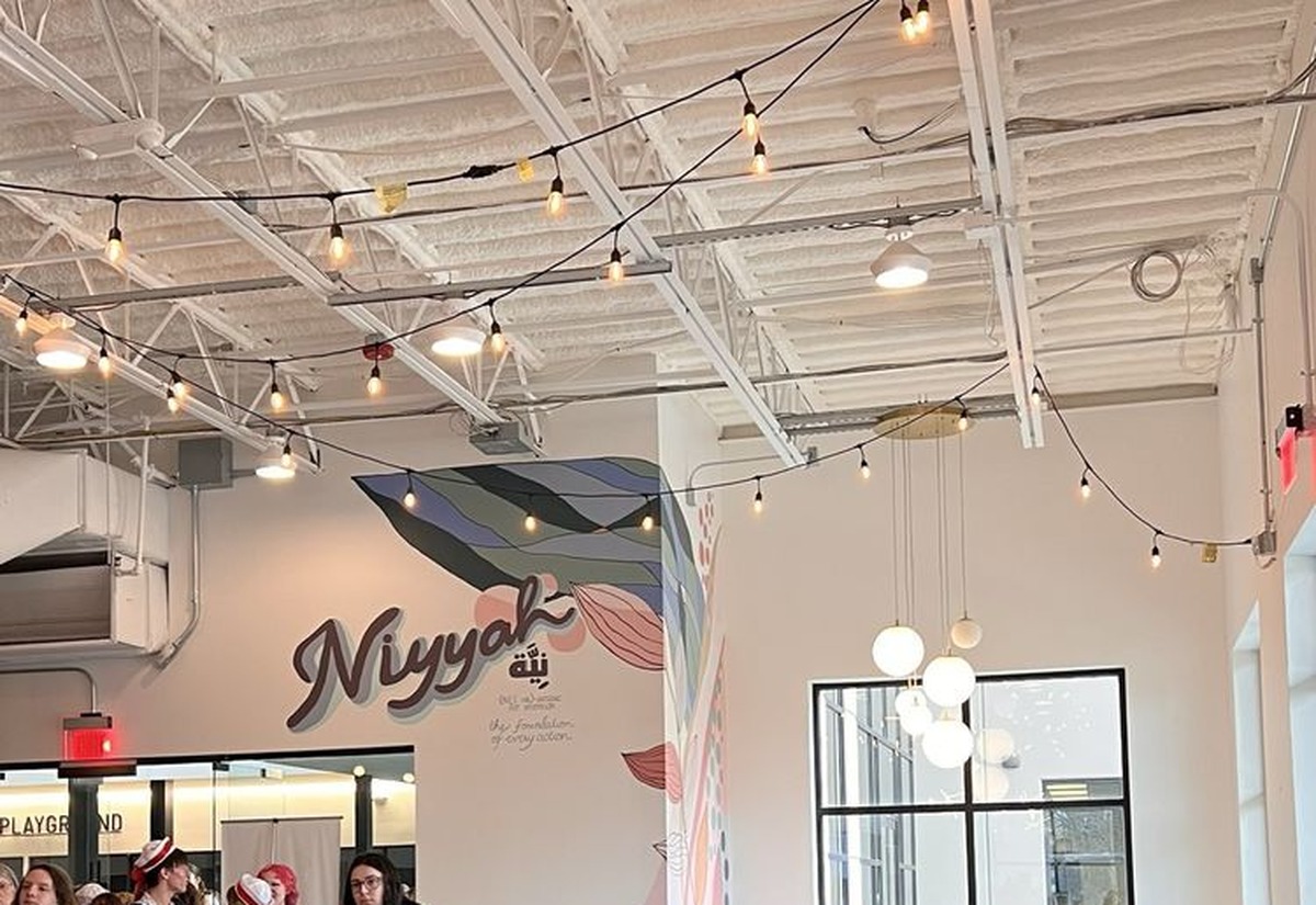 Inside Niyyah Coffee at Hub & Spoke — Niyyah mural, seating, and community space